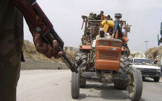 Một xe kéo chở người tị nạn đi qua trạm kiểm soát ở Bannu, Pakistan. 