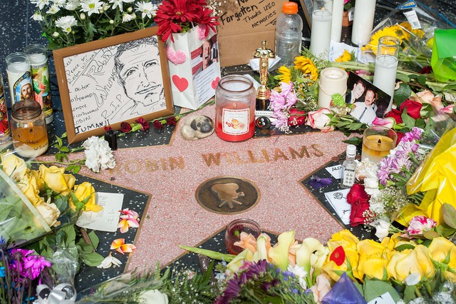 Người hâm mộ để lại hoa và kỉ vật tại Đại lộ Danh vọng để tưởng nhớ Robin Williams. Một diễn viên hài mang lại tiếng cho hàng triệu người suốt nhiều năm qua, anh đã không thể tìm được niềm vui trong chính cuộc đời mình và quyết định tự vẫn hồi tháng 8 vừa qua. Ảnh: Valerie Macon/Getty Images