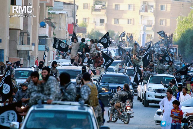 Islamic State fighters parade through Raqqa, their stronghold in Syria, in June.