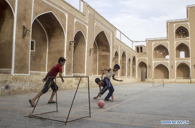 Các cậu bé chơi bóng đá tại thành phố Yazd, Iran.