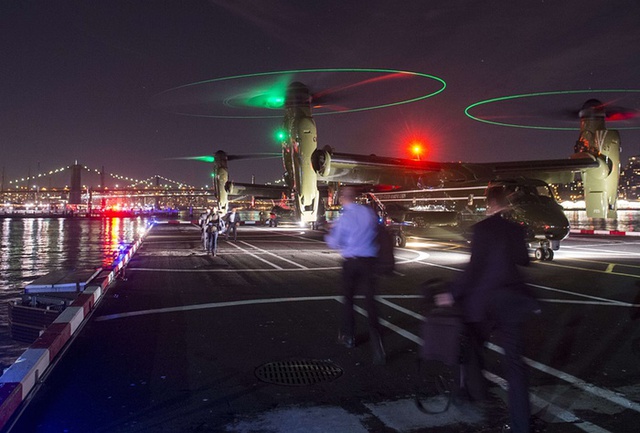 Phóng viên và nhân viên an ninh di chuyển cùng Tổng thống Mỹ Barack Obama tới một chiếc trực thăng để rời khỏi thành phố New York.