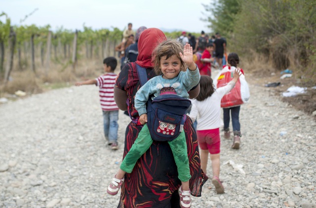 Người di cư vượt qua biên giới từ Hi Lạp sang thị trấn Gevgelija, Macedonia.