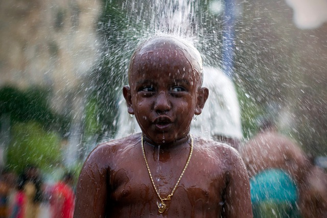 Cậu bé người Hindu ở Kuala Lumpur, Malaysia được tắm rửa trong nghi lễ làm sạch trước cuộc hành hương trong lễ hội Thaipusam.