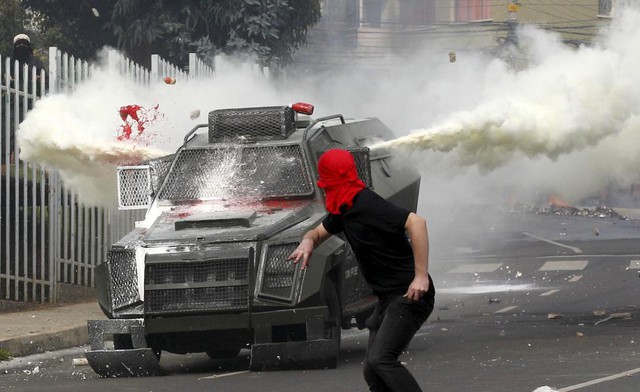 Một sinh viên động độ với cảnh sát chống bạo động trong cuộc biểu tình đòi cải cách hệ thống giáo dục ở Valparaiso, Chile.