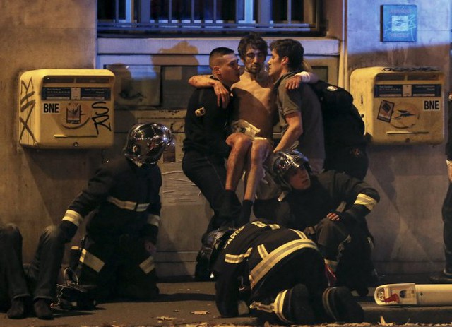 Đội cứu hộ giúp đỡ một nạn nhân bị thương gần nhà hát Bataclan sau vụ nổ súng chết người ở Paris, Pháp, ngày 13 -11.