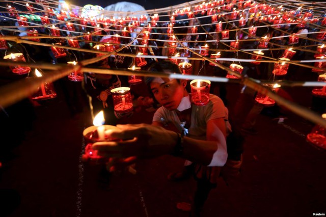 Mọi người thắp nến trước khi thả đèn trời trong lễ hội truyền thống Tazaungdaing ở Taunggyi, Myanmar.
