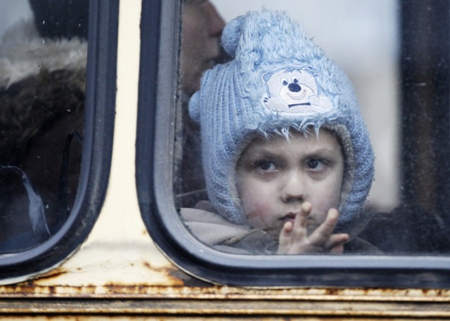 Em bé ngồi trên xe bus để rời khỏi thị trấn Debaltseve, miền đông Ukraine. Đây là khu vực đang diễn ra các cuộc giao tranh ác liệt giữa quân đội chính phủ Kiev và phe ly khai.