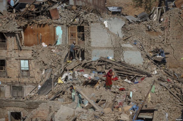 Những người sống sót sau thảm họa động đất tìm kiếm đồ đạc của họ trong đổ nát ở ngoại ô thành phố Kathmandu, Nepal.