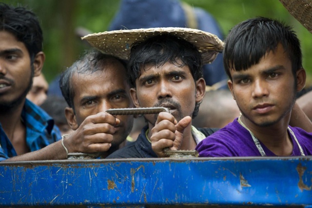 Những người nhập cư đứng trên xe tải gần hàng rào biên giới ở Taung Pyo, Myanmar, trước khi hồi hương về Bangladesh.