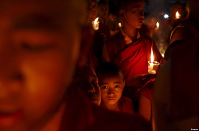 Các nhà sư thắp nến cầu nguyện cho nạn nhân thiệt mạng do động đất ở Kathmandu, Nepal.