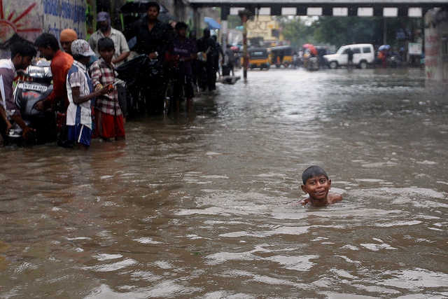 Cậu bé bơi trên đường phố ngập lụt ở thành phố Chennai, Ấn Độ.