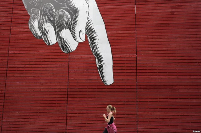Người phụ nữ chạy bộ qua bức tranh tường ở trung tâm London, Anh.