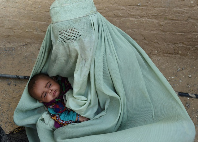 Người phụ nữ tị nạn Afghanistan bế con nhỏ tại một trại tị nạn tạm ở ngoại ô thành phố Quetta, Pakistan.