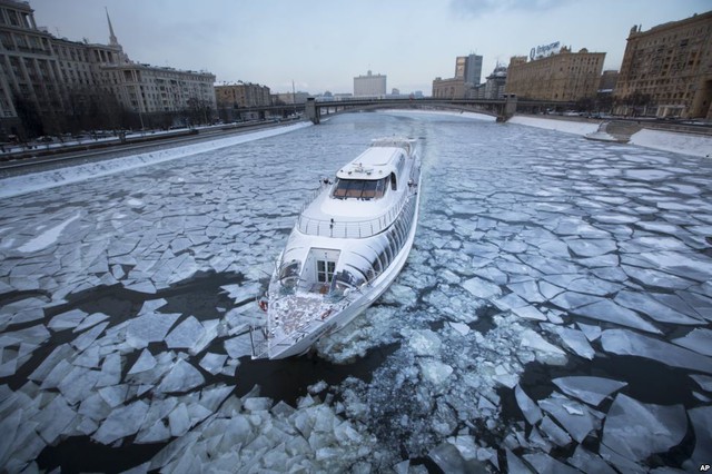 Tàu du lịch di chuyển trên mặt nước đóng băng dưới sông Moskva ở Moscow, Nga.