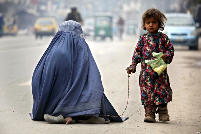 Bé gái và mẹ ăn xin trên đường phố ở Peshawar, Pakistan.