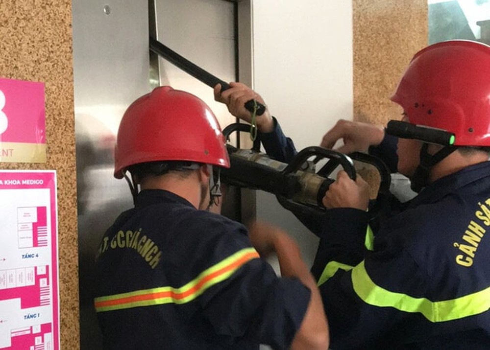 Cảnh sát phá cửa thang máy, cứu 9 người bị mắc kẹt - Ảnh 1.