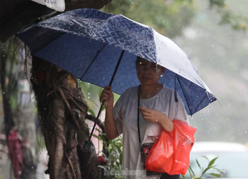Cơn mưa vàng giải nhiệt sau mấy ngày nắng nóng kỷ lục ở Thủ đô - Ảnh 6.