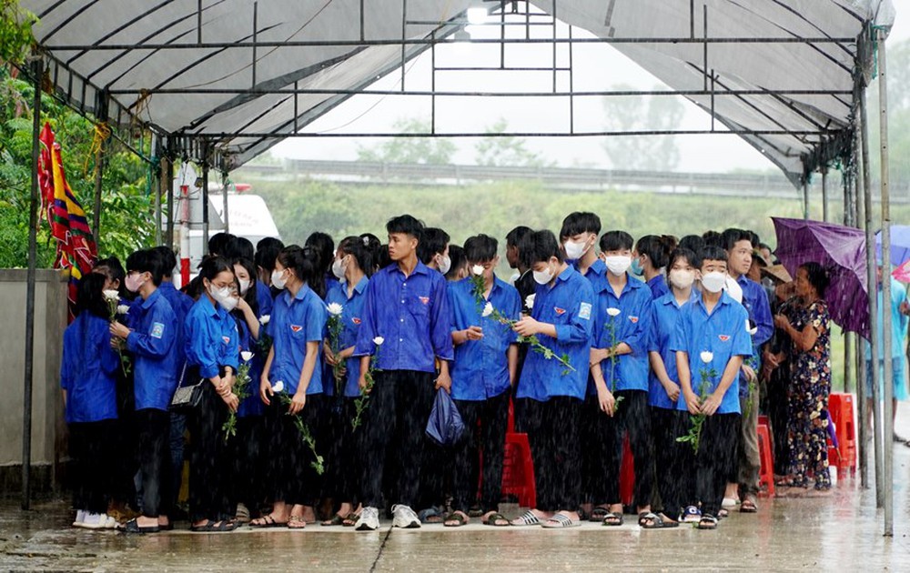 Hàng trăm người dân đội mưa cầm hoa cúc trắng đón liệt sĩ Lê Ánh Sáng - Ảnh 2.