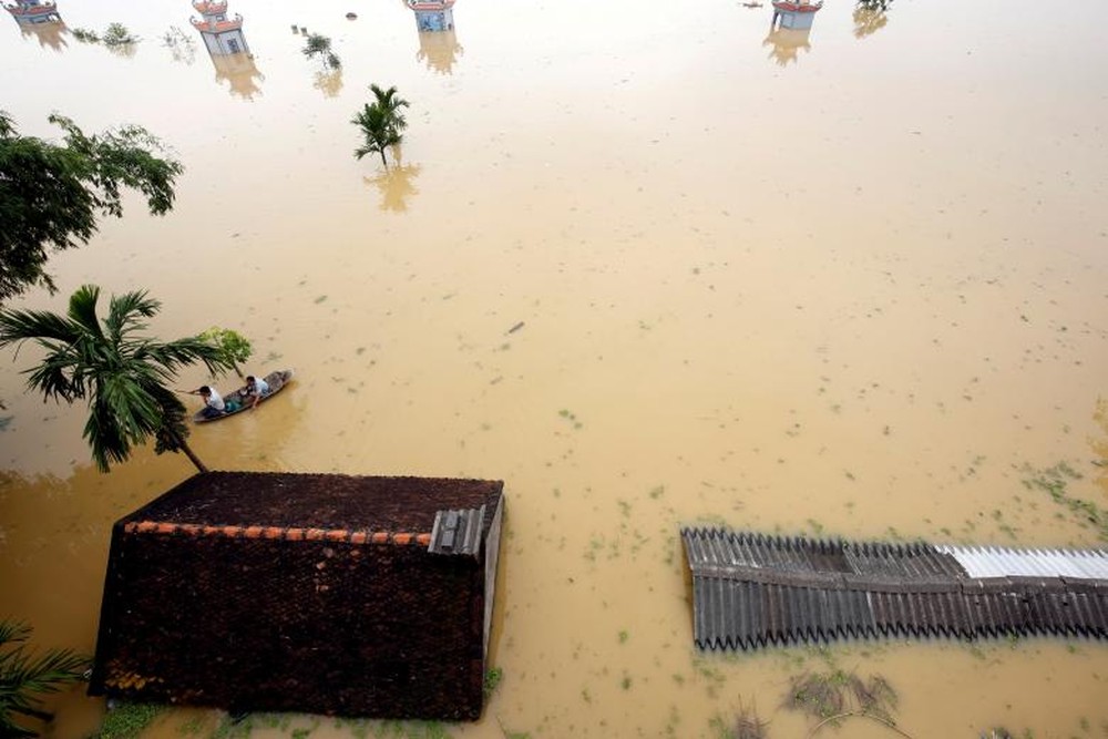 24h qua ảnh: Nông dân chèo thuyền trên nước lụt ngập mái nhà - Ảnh 4.