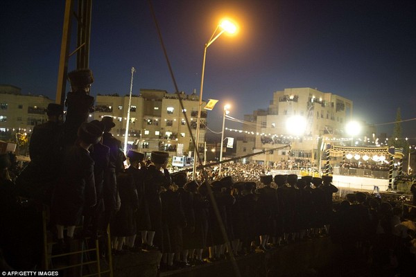 Well-wishers: Tens of thousands of Ultra-Orthodox Jews of the Belz Hasidic Dynasty watch the wedding ceremony of Rabbi Shalom Rokach