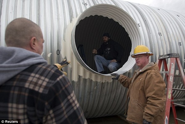 Planned: Paul Seyfried, right talks with staff members Troy Schiff, left, and Dave Cox about a bunker they are constructing for a client at Utah Shelter Systems