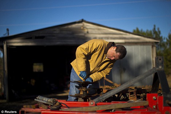 Self-reliance: Nice repairs a tractor disk at his farm