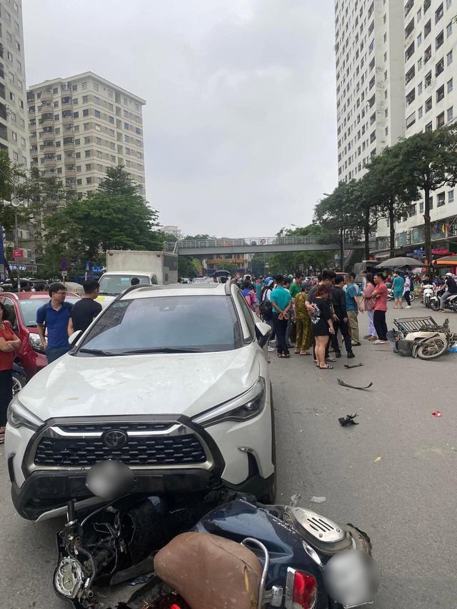 Clip tai nạn hãi hùng ở Hà Nội: Ô tô tông vào đuôi xe máy, hất người lên nắp capo rồi văng xuống đường- Ảnh 1.