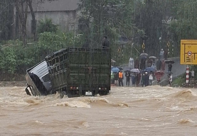 Xe tải bị lũ cuốn trôi, tài xế leo lên cabin đợi ứng cứu nhưng không kịp- Ảnh 1.