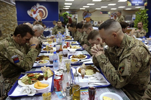 Quân đội Mỹ cầu nguyện trước một bữa ăn trong dịp lễ Tạ ơn tại một căn cứ quân sự NATO ở Kabul, Afghanistan.