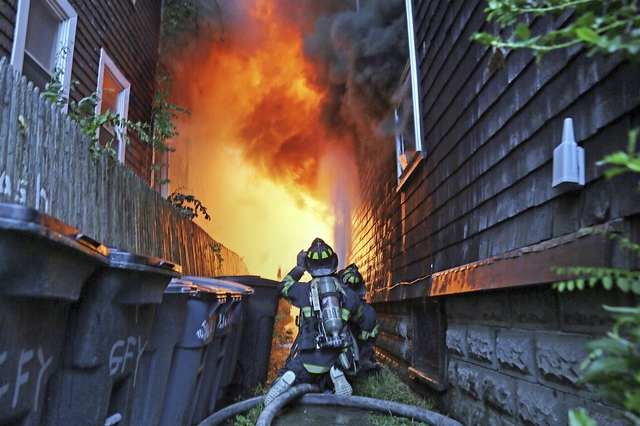 Lính cứu hỏa đang cố gắng dập tắt lửa bùng phát dữ dội trên một tòa nhà chung cư 5 tầng ở thành phố Somerville, Massachusetts, Mỹ.