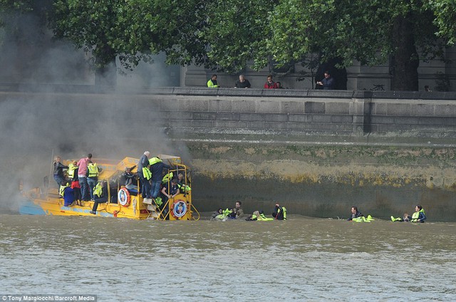 In the water: These photographs show passengers being rescued after smoke began pouring from a London Duck Tours amphibious vehicle