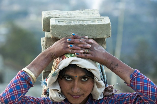 Công nhân đội gạch trên đầu trong một nhà máy ở Lalitpur, Nepal.