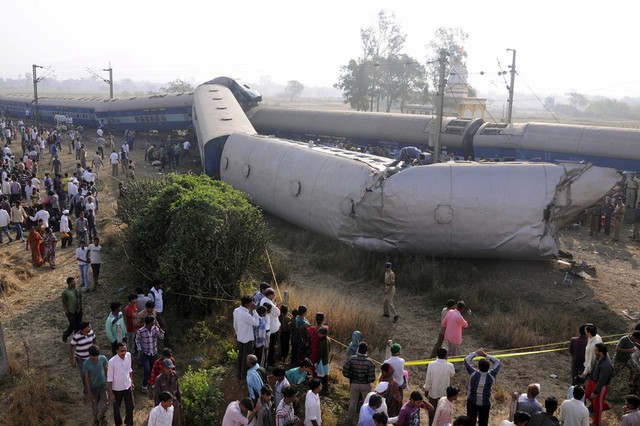 Nhân viên cứu hộ và người dân nhìn đoàn tàu bị trật đường ray ở Maharashtra, Ấn Độ. Tai nạn khiến vài người thiệt mạng và hàng chục người bị thương.