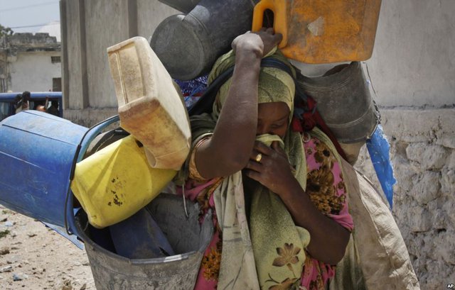 Một phụ nữ vừa khóc vừa mang đồ trong khi đi sơ tán khỏi các cuộc xung đột ở Mogadishu, Somalia.
