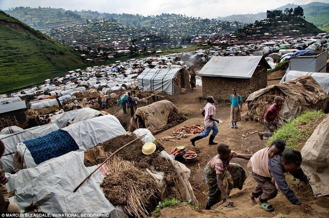 Điều kiện phụ con người: Trẻ em tranh giành một sườn đồi tại một trại tị nạn ở Rubaya, nơi người dân địa phương bỏ chạy như một kết quả của sự đấu tranh giữa M23 và quân đội Congo