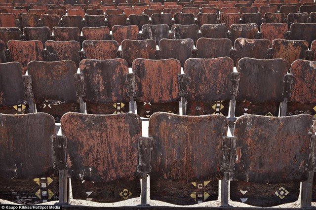 The 150 wooden seats are weathered and worn by the apocalyptic surroundings, and remain empty