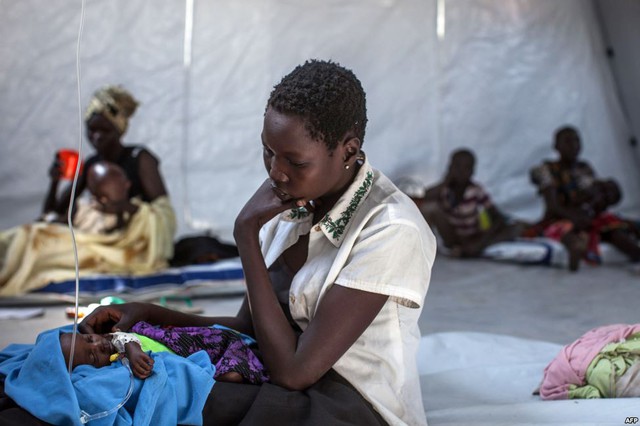 Một bà mẹ ngồi trông con mới chào đời đang được chăm sóc tại trung tâm y tế của Tổ chức bác sĩ không biên giới ở Minkammen, Nam Sudan.