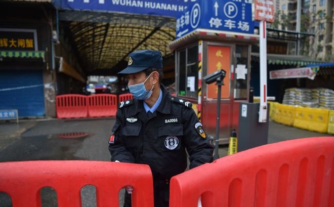 Một sĩ quan cảnh sát đứng canh gác bên ngoài chợ bán buôn hải sản Hoa Nam tại Vũ Hán ngày 24/1/2020, nơi được cho là điểm khởi phát dịch COVID-19. (Ảnh: Getty Images)