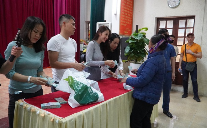 Vợ chồng Công Vinh - Thủy Tiên trao tiền cứu trợ lũ lụt cho 458 hộ dân của 7 xã huyện Hưng Nguyên (Nghệ An) tại hội trường UBND huyện.