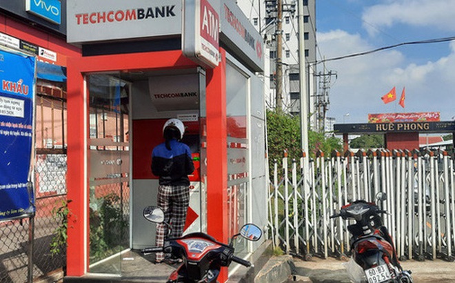 Thưa thớt chủ thẻ rút tiền qua ATM tại cổng nhà máy Công ty Giày Huê Phong , quận Gò Vấp, TPHCM