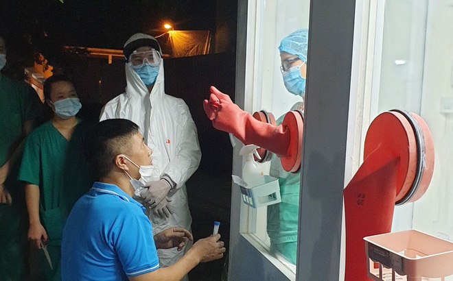 Nhân viên y tế huyện Tân Yên thử nghiệm quy trình tại buồng lấy mẫu xét nghiệm chống nóng. Ảnh: Thu Quỳnh.