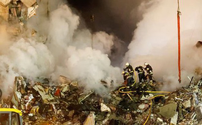 Lực lượng cứu hộ vẫn đang nỗ lực tìm kiếm thêm người giữa đống đổ nát hôm 14-1 - Ảnh: REUTERS