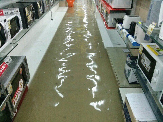 Mưa lớn ở Sài Gòn, nước tràn vào siêu thị điện máy - Ảnh 1.