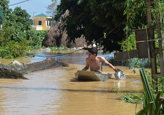 Chùm ảnh: Nhà ngập sâu đến ngang cửa, người dân Ninh Bình dùng chậu nhôm, ghế gỗ chèo thuyền đi lại trong ngõ - Ảnh 3.