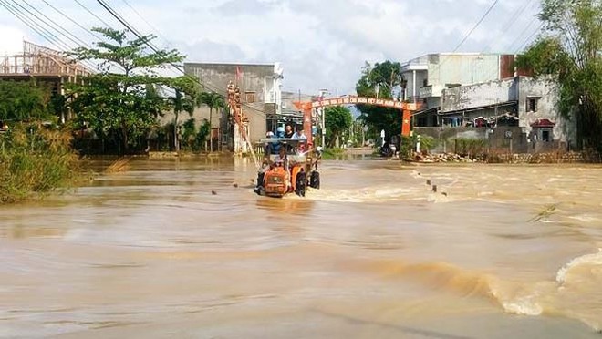 Đường phố Bình Định chìm trong biển nước, người dân dùng máy cày vượt lũ - Ảnh 7.