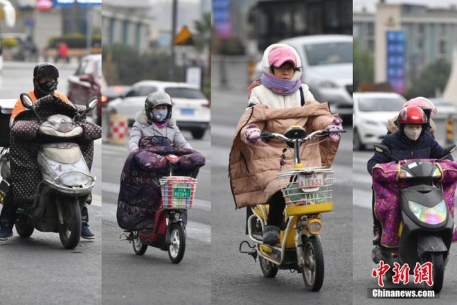 Trung Quốc lạnh âm độ trong trận Đại Tuyết, người dân quấn áo choàng dày như chăn ra đường - Ảnh 11.