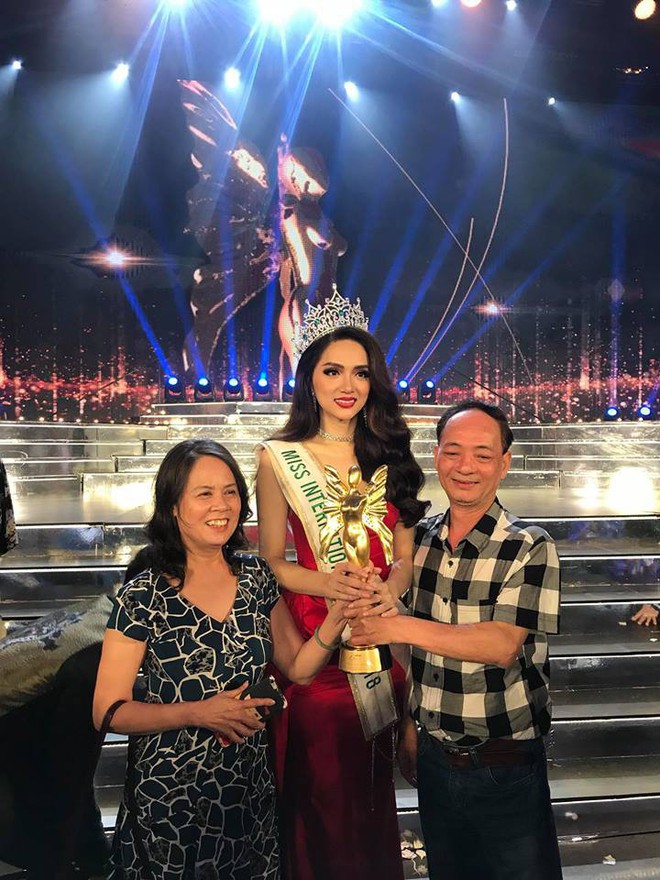 Bố mẹ ruột hôn má chúc mừng Hương Giang và cùng nắm chặt cúp Hoa hậu Chuyển giới Quốc tế - Ảnh 1.