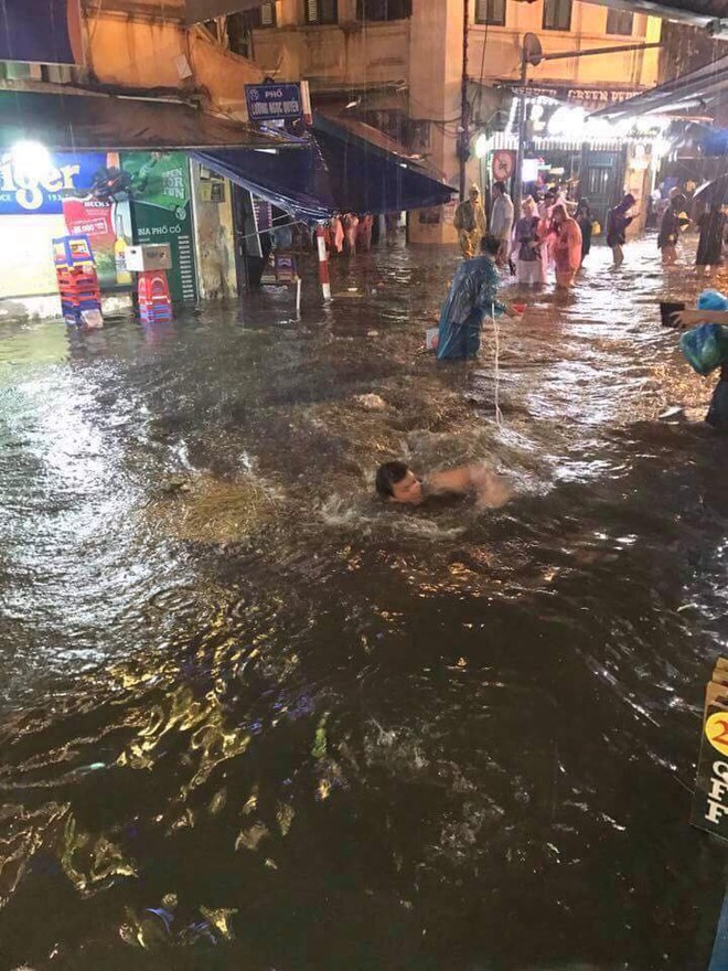 Chàng Tây thích thú nhảy xuống đường, bơi trên phố Tạ Hiện sau cơn mưa dông tối qua - Ảnh 2.