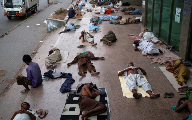 24h qua ảnh: Người dân ngủ la liệt trên vỉa hè để tránh đợt nắng nóng khủng khiếp - Ảnh 2.