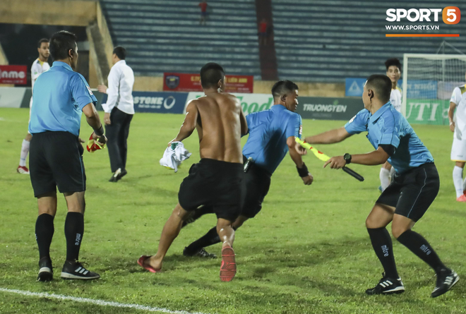 Cận cảnh CĐV Nam Định rượt đuổi trọng tài, đánh phóng viên trên sân Thiên Trường - Ảnh 1.